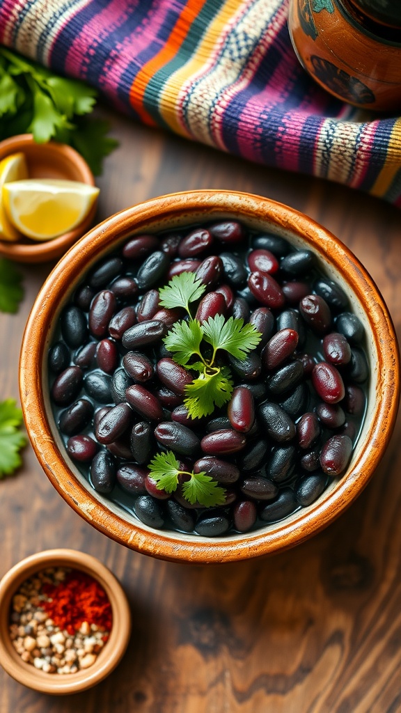A bowl of seasoned black beans garnished with cilantro on a rustic table with spices and lime.